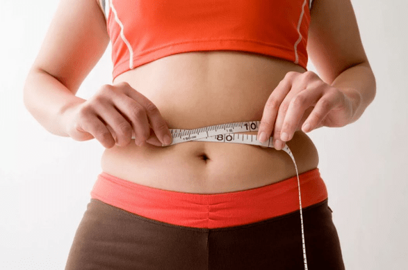 Girl measuring the volume of waist